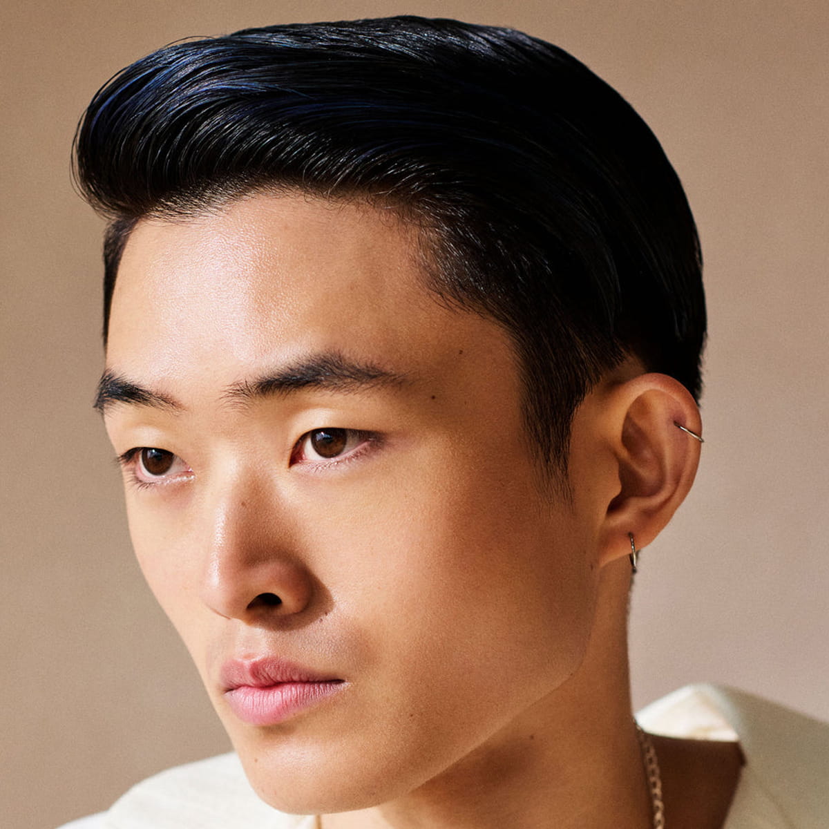 Model of young man with Innersense Organic Beauty Inner Reflection Sculpting Pomade used in hair