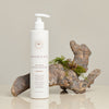 Innersense Organic Beauty Hair Renew Soothing Conditioner - product shown in front of piece of wood.