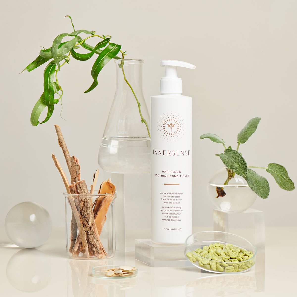 Innersense Organic Beauty Hair Renew Soothing Conditioner - product shown in front of plants.
