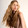 Innersense Organic Beauty Overnight Repair Serum used on woman with long, wavy blonde hair