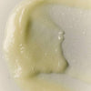A close-up swatch of BASE-K The Rice Powder Detox Micro-Exfoliating Scalp Scaling Shampoo