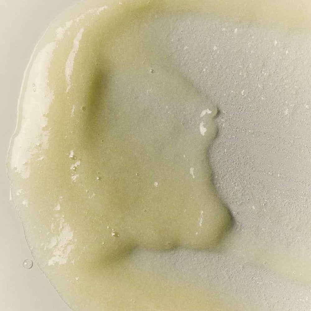 A close-up swatch of BASE-K The Rice Powder Detox Micro-Exfoliating Scalp Scaling Shampoo