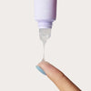 Cote The Ritual Peptide Enriched Lip Treatment (10 ml)  - product shown being applied to woman's finger.