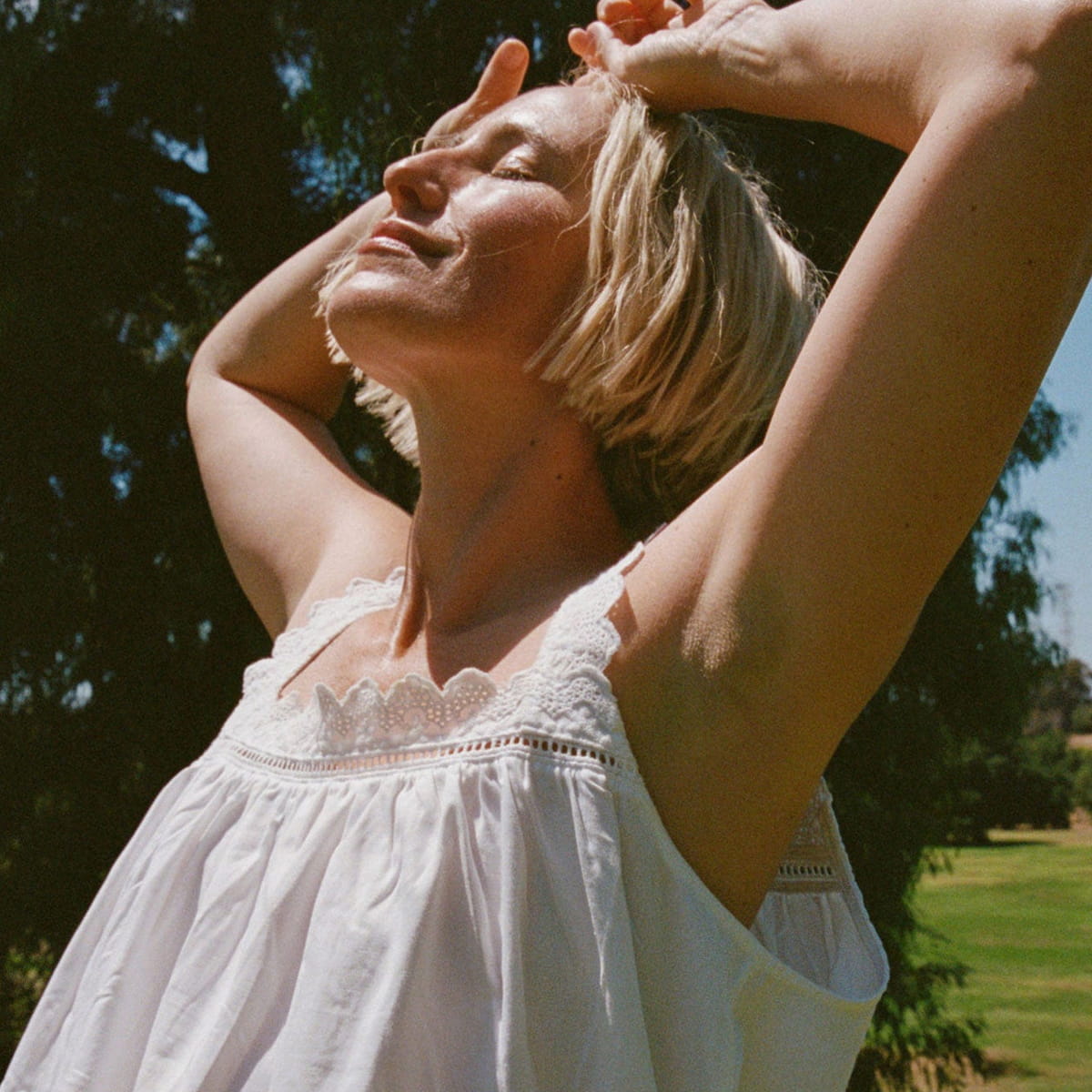 Ursa Major Forest Fix Spray Deodorant (1.85 oz) - model shown with her arms up.