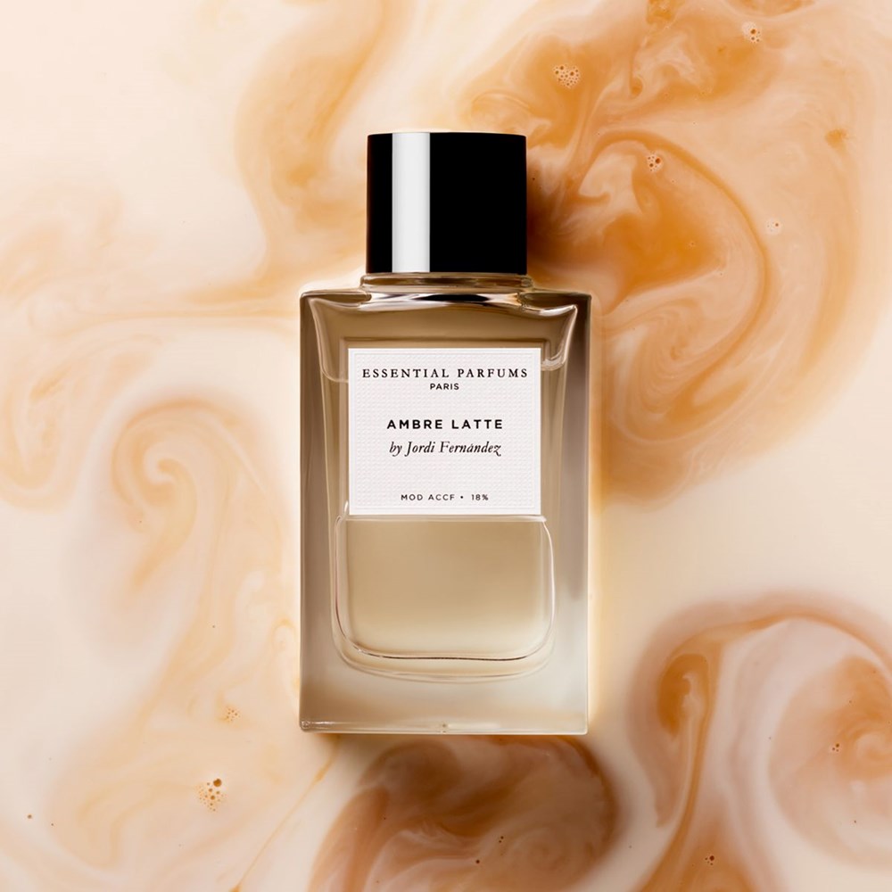 Essential Parfums Ambre Latte by Jordi Fernandez (100 ml Refillable) - product shown on top of a coffee background.