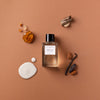 Essential Parfums Ambre Latte by Jordi Fernandez (100 ml Refillable) - product shown on brown background.