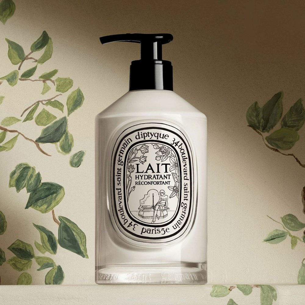 Diptyque Comforting Moisturizing Lotion (350 ml) - product shown on counter with leafy background.