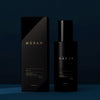 Heretic Parfum Haxan Body Oil (150 ml) - product shown on blue background. 