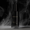 Heretic Parfum Haxan Body Oil (150 ml) - product shown surrounded by smoke on black background