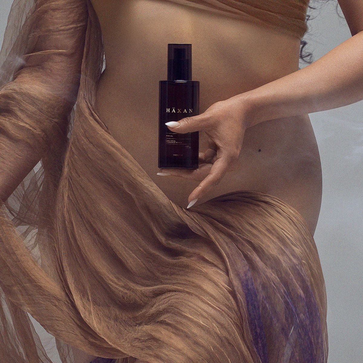 Heretic Parfum Haxan Body Oil (150 ml) - product shown being held by model!