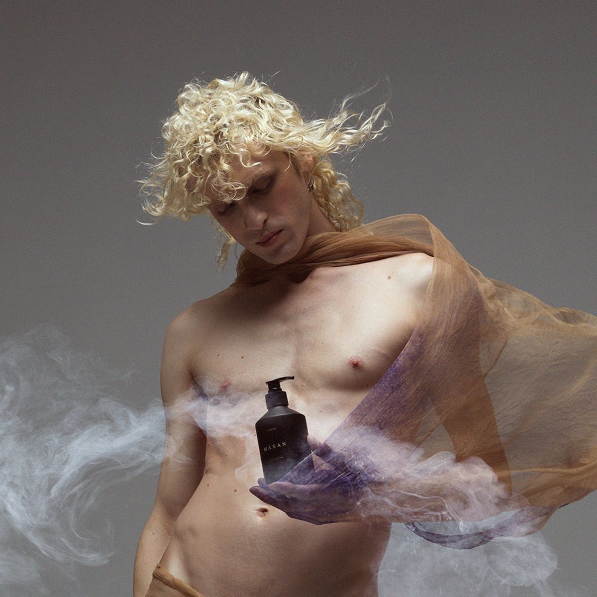 Heretic Parfum Haxan Body Wash (400 ml) - product shown being held by model. 