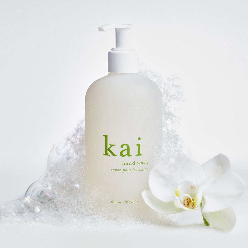 Kai Fragrance Hand Wash (12 oz) - product shown with suds and flower.