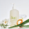 Kai Fragrance Hand Wash (12 oz) - product shown with flowers and ingredients around it.