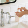 Kai Fragrance Hand Wash (12 oz) - product shown being used at bathroom sink. 