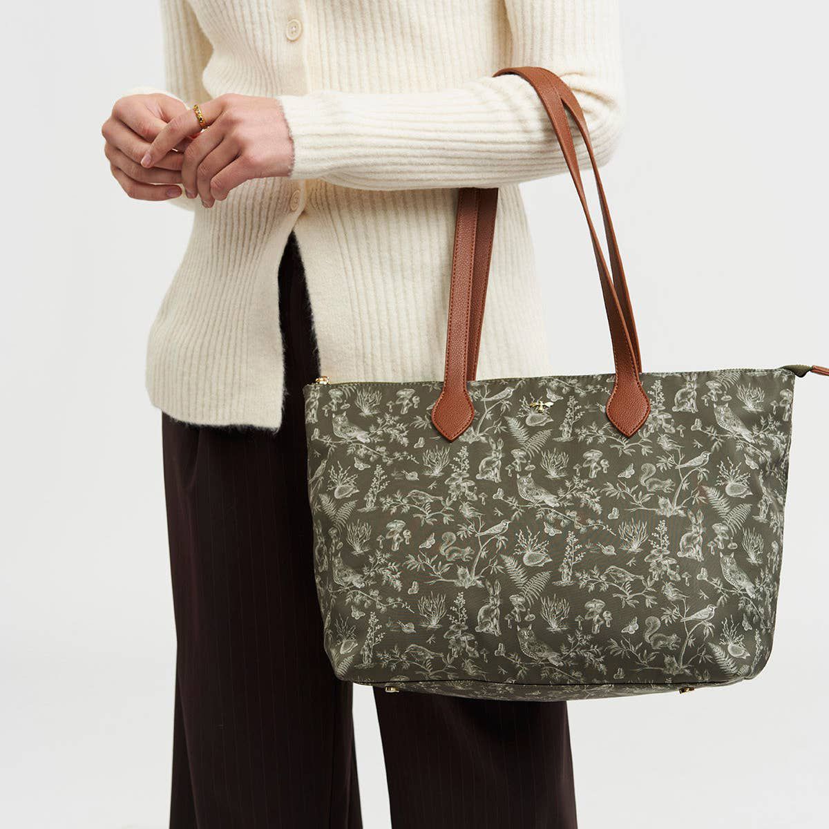 Fable England Edith Orla Scene Print Tote Bag - Khaki (1 pc) - product shown being held by model. 