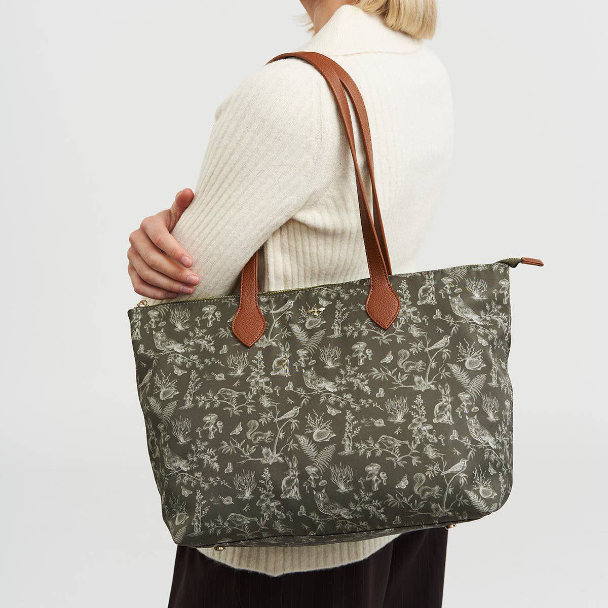 Fable England Edith Orla Scene Print Tote Bag - Khaki (1 pc) - product shown being held by model. 