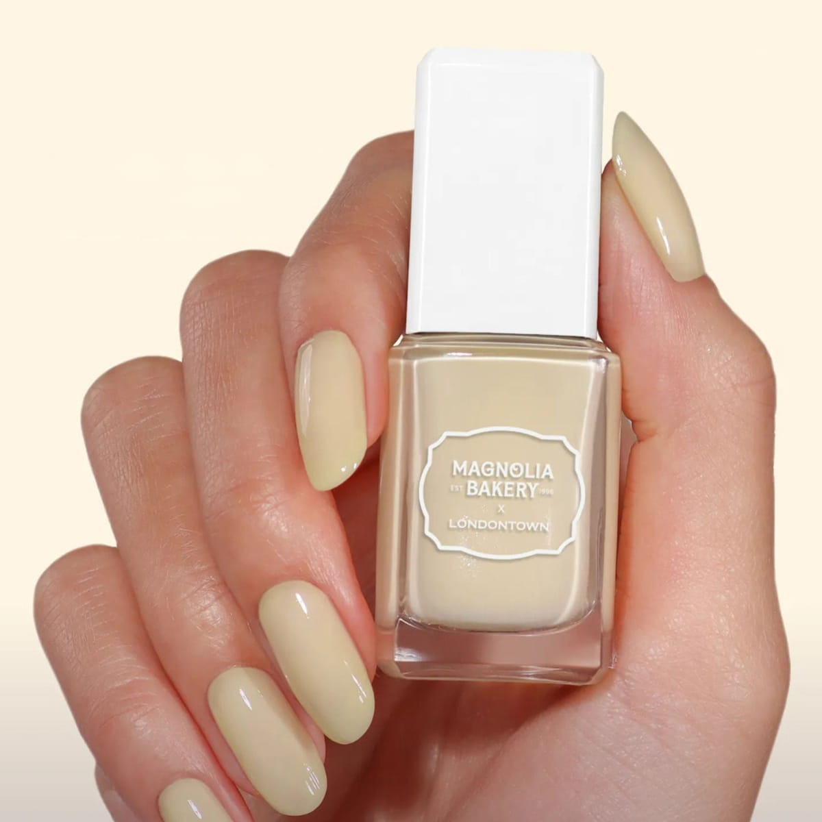 Londontown Magnolia Bakery x Londontown Nail Polish - Banana Pudding (12 ml) - product shown being held up.
