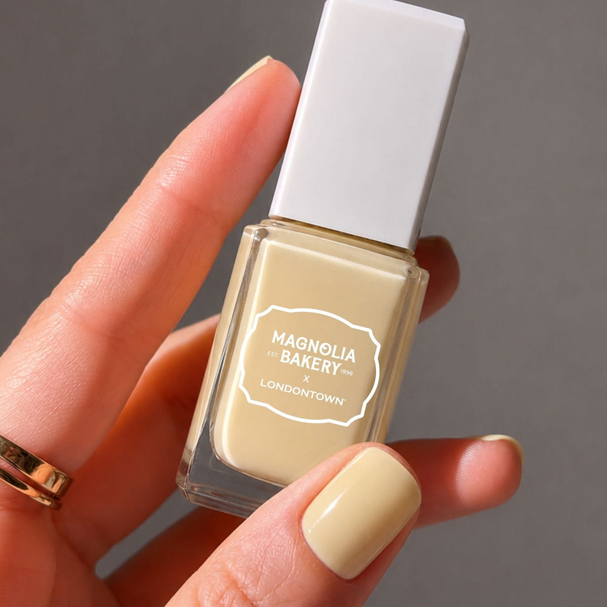Londontown Magnolia Bakery x Londontown Nail Polish - Banana Pudding (12 ml) - product shown being held. 