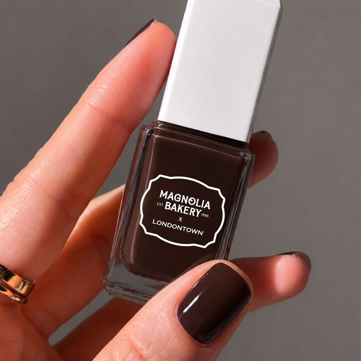 Londontown Magnolia Bakery x Londontown Nail Polish - Double Fudge (12 ml) - product shown being held. 
