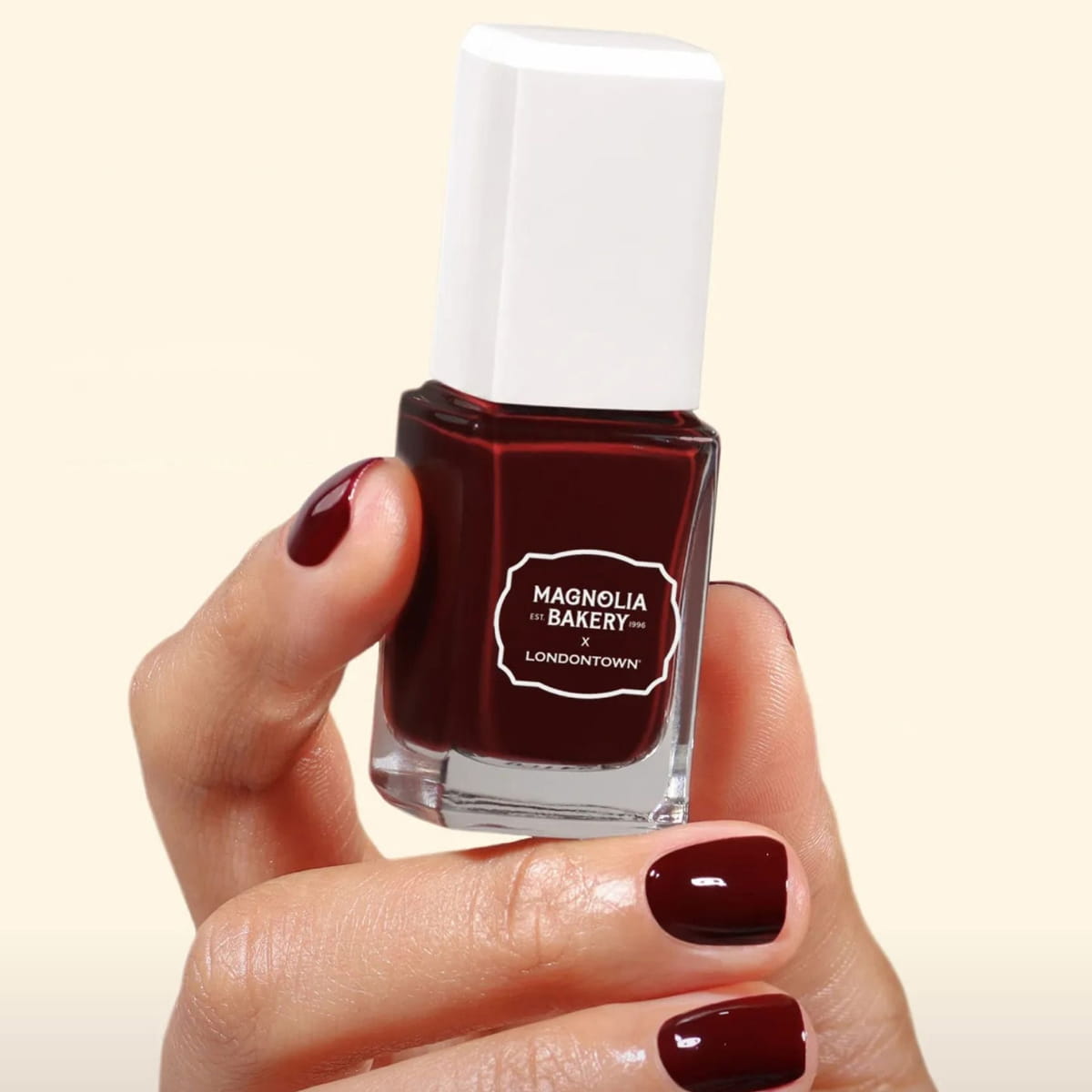 Londontown Magnolia Bakery x Londontown Nail Polish - Red Velvet (12 ml) - product shown being held. 