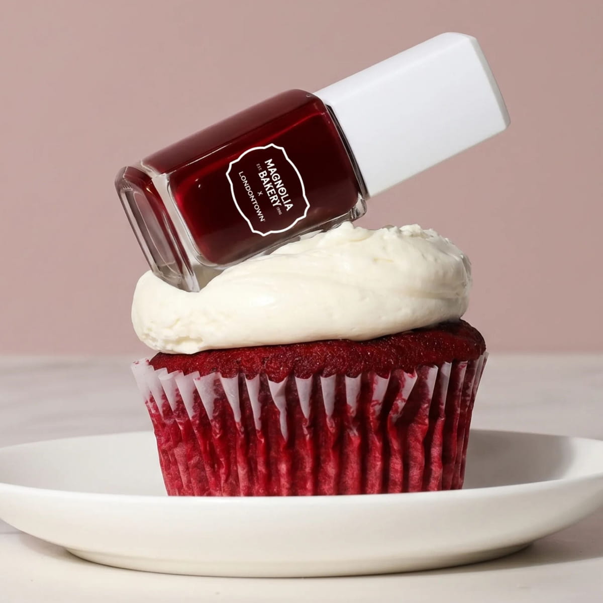 Londontown Magnolia Bakery x Londontown Nail Polish - Red Velvet (12 ml) - product shown on top of cupcake. 