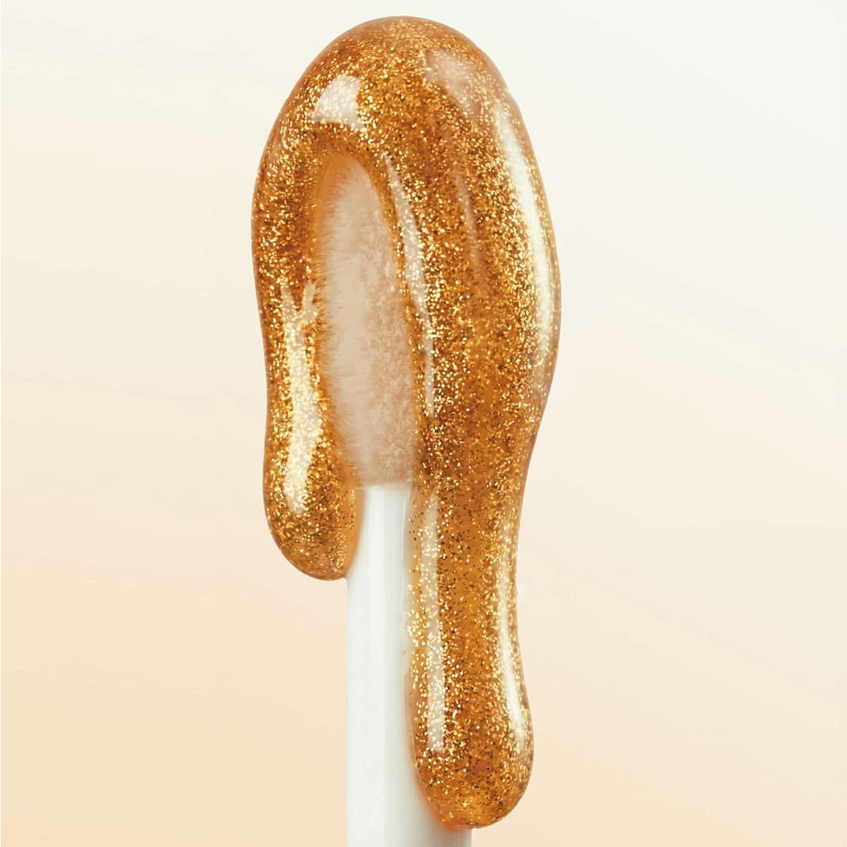 Nuxe Reve de Miel Gold Honey Lip Care (10 ml) - product shown on applicator. 