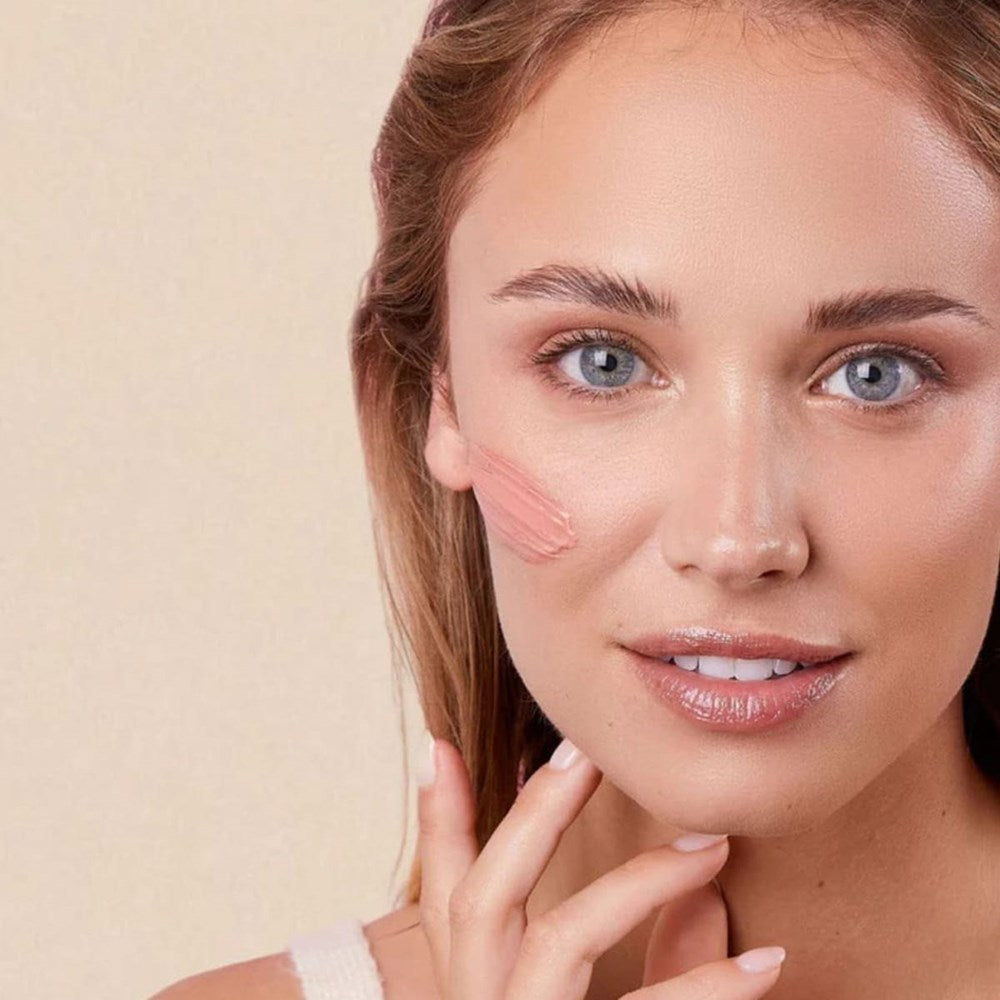 Embryolisse Radiant Complexion Cream - Rose Glow (30 ml) - product shown swatched on model's face. 