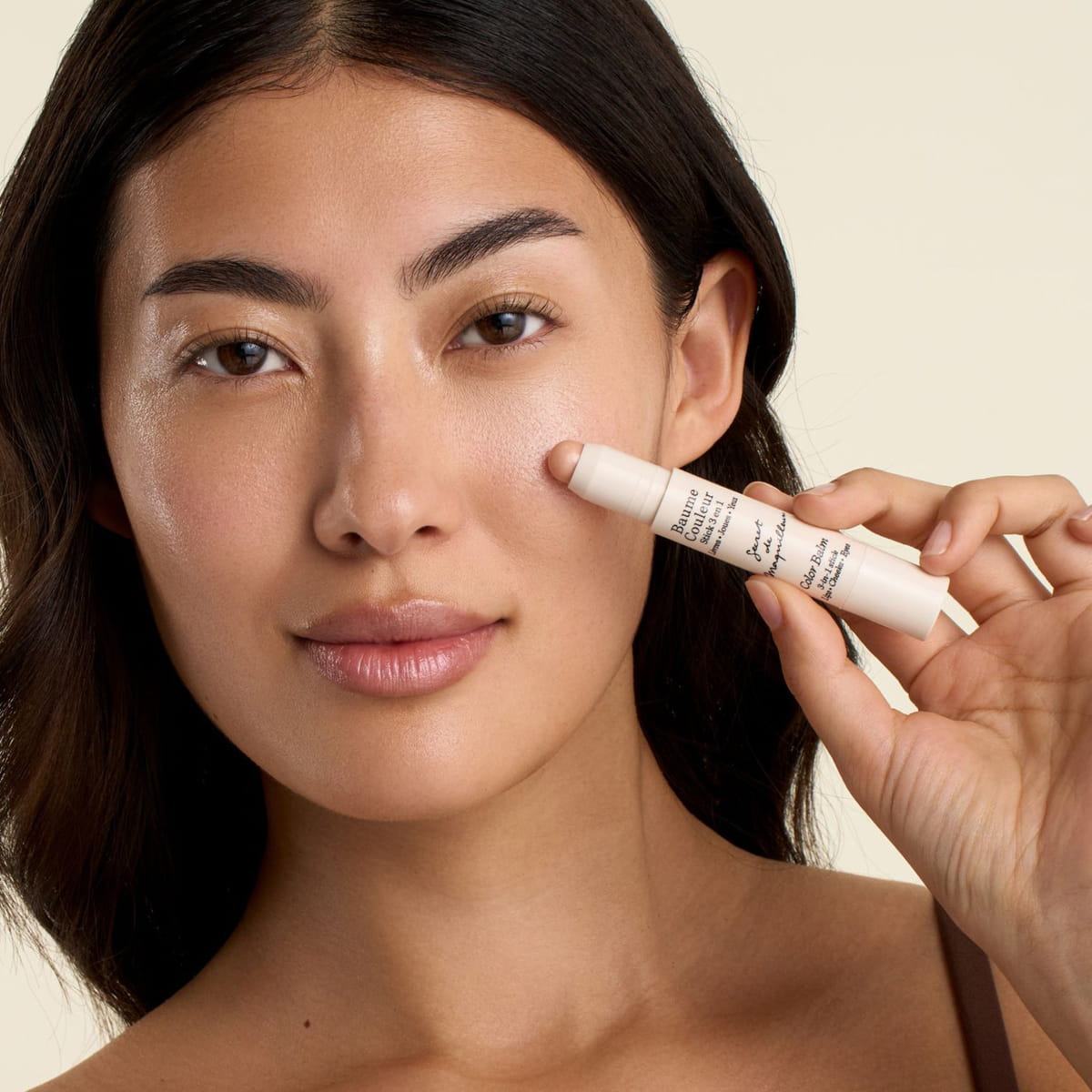 Embryolisse Color Balm 3-in-1 Stick - Champagne (2.5 g) - product shown on cheeks. 