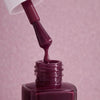 Kure Bazaar Nail Lacquer - Burgundy (10 ml) - product shown with lid removed.