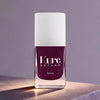 Kure Bazaar Nail Lacquer - Burgundy (10 ml) - product shown on marble counter top.