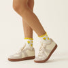 Effortless Club Lemon Ruffle Grip Sock (1 pair) - product shown with shoes on. 