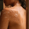 Susanne Kaufmann Body Wash for the Senses (200 ml) - product shown lathered on woman's skin. 