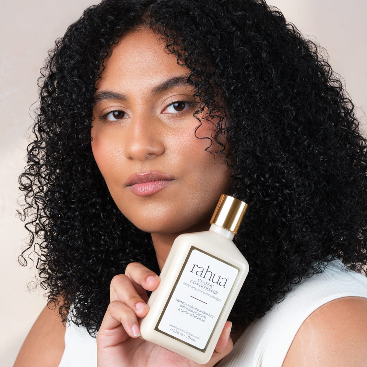 Rahua Classic Conditioner (275 ml) - model shown holding product.