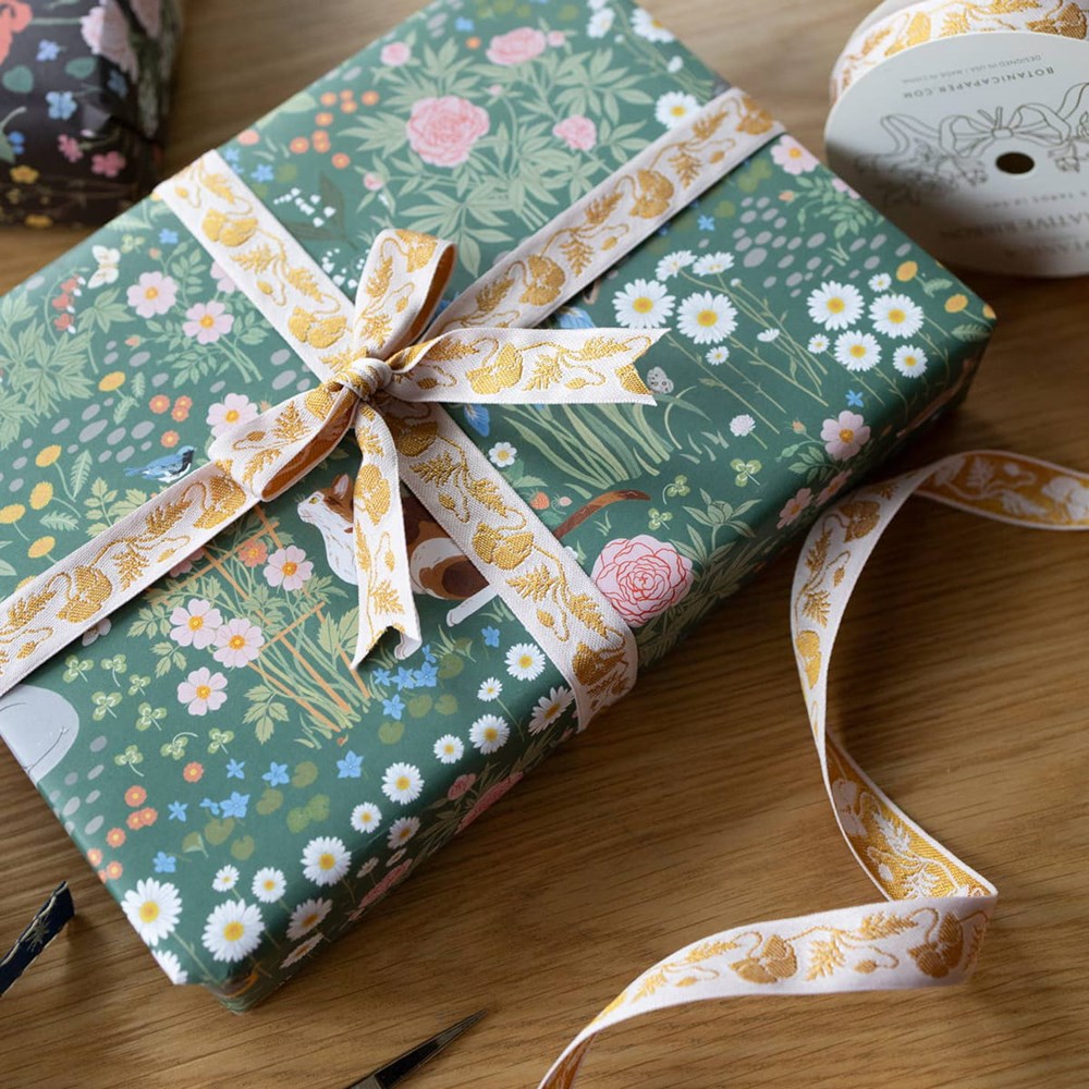 Botanica Paper Co. Gold Poppy Embroidered Ribbon (0.75” x 5 yards) shown on wrapped gift