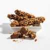 Charles Chocolates Caramel Almond Sticks in a dish with one stick cut in half in the foreground