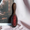 L'Artisan Brossier Pure Boar & Nylon Bristle Brush - Medium (1 pc) - product shown on pink sheet. 
