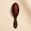 L'Artisan Brossier Pure Boar Bristle Brush - Medium (1 pc) - product shown on creme background.