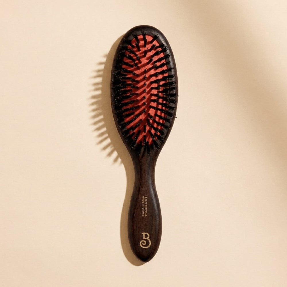 L'Artisan Brossier Pure Boar Bristle Brush - Medium (1 pc) - product shown on creme background.