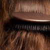 L'Artisan Brossier Pure Boar Bristle Brush - Large (1 pc) - products shown brushing hair.