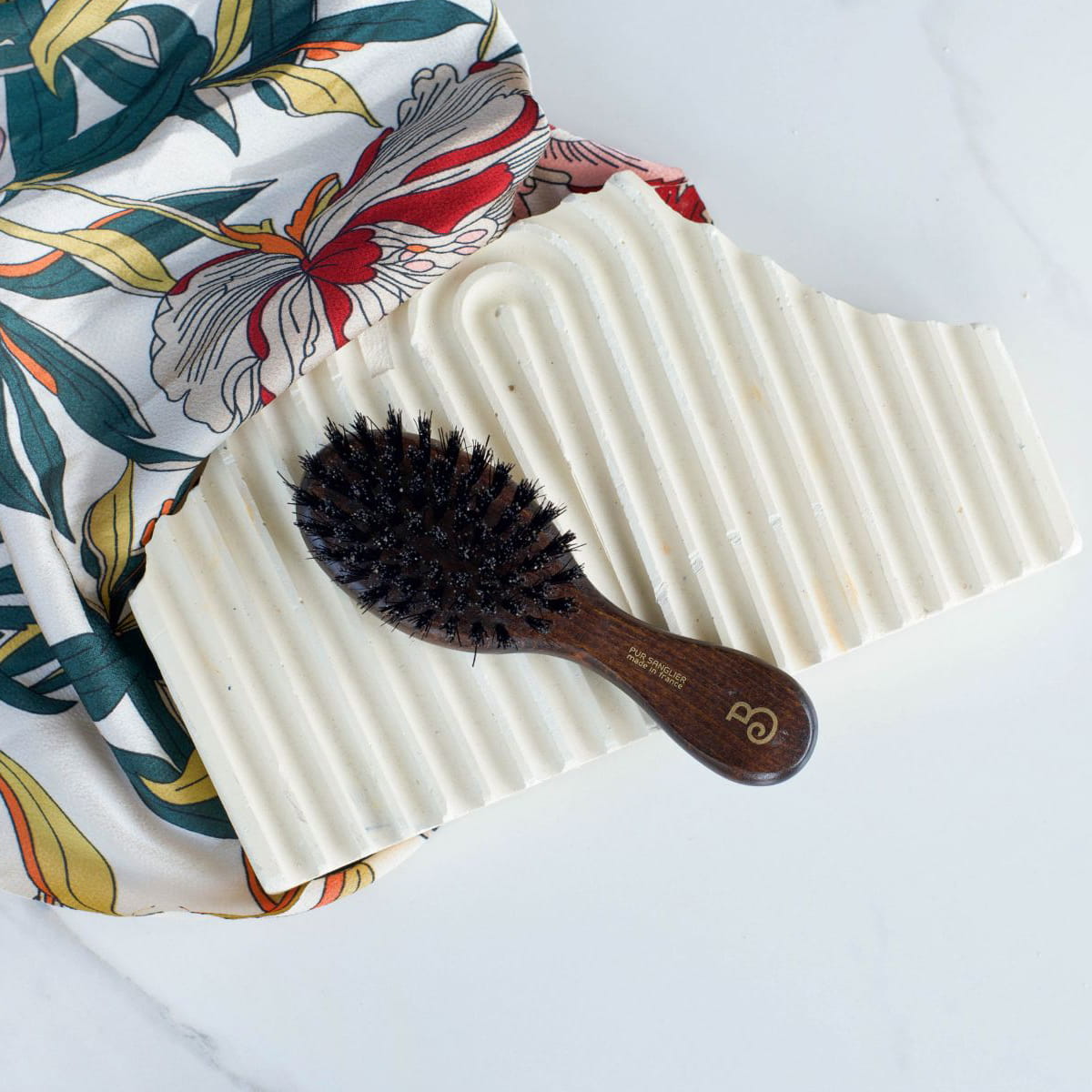 L'Artisan Brossier Pure Boar Bristle Hand Bag Brush (1 pc) - product shown on ceramic slab.