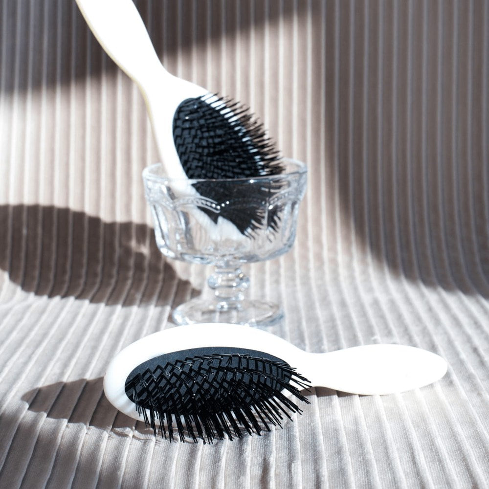 L'Artisan Brossier Bio-Based Nylon Bristle Brush - Medium (1 pc) - product shown on cloth.