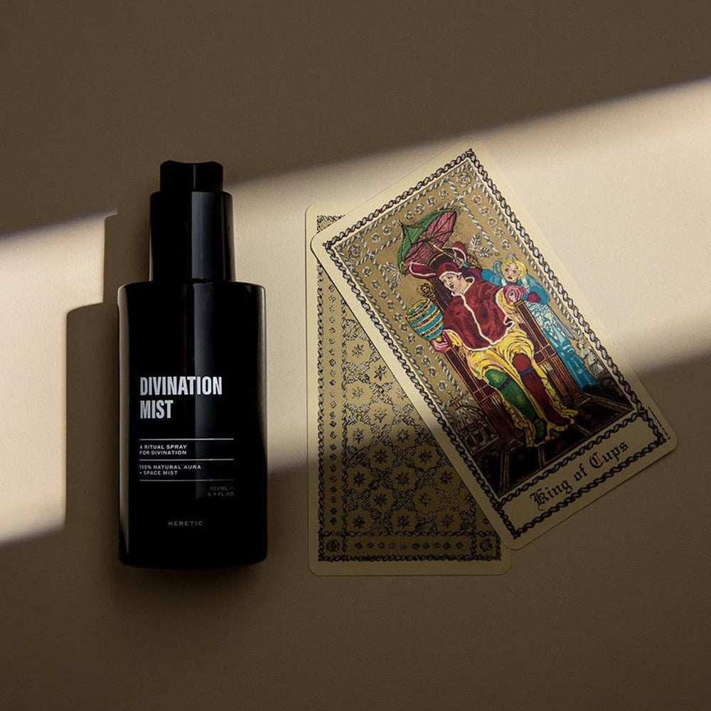 Heretic Parfum Divination Mist (100 ml) - product shown next to tarot cards. 