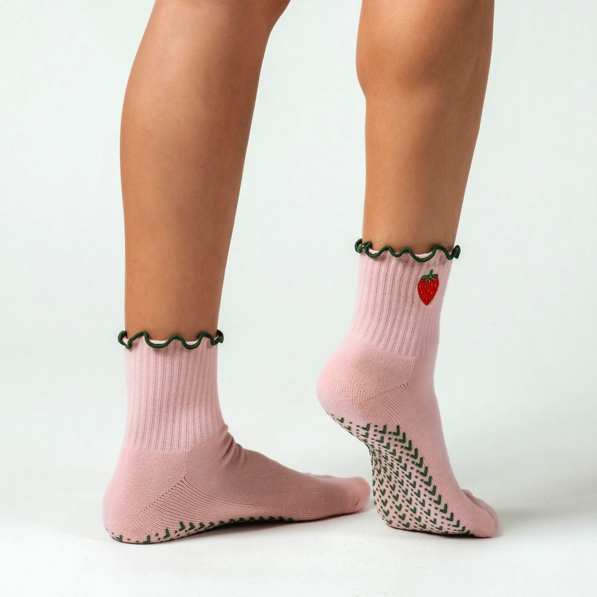 PikeFit Strawberry Shortcake Grip Socks shown on feet of model - available in S/M and M/L. One sock is shown from the side, the other showing the bottom of the foot.