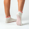 A pair of PikeFit Princess Grip Socks shown on feet of model (back and bottom view) - available in S/M and M/L, shown on a person's feet. One sock is shown from the side, the other showing the bottom of the foot.