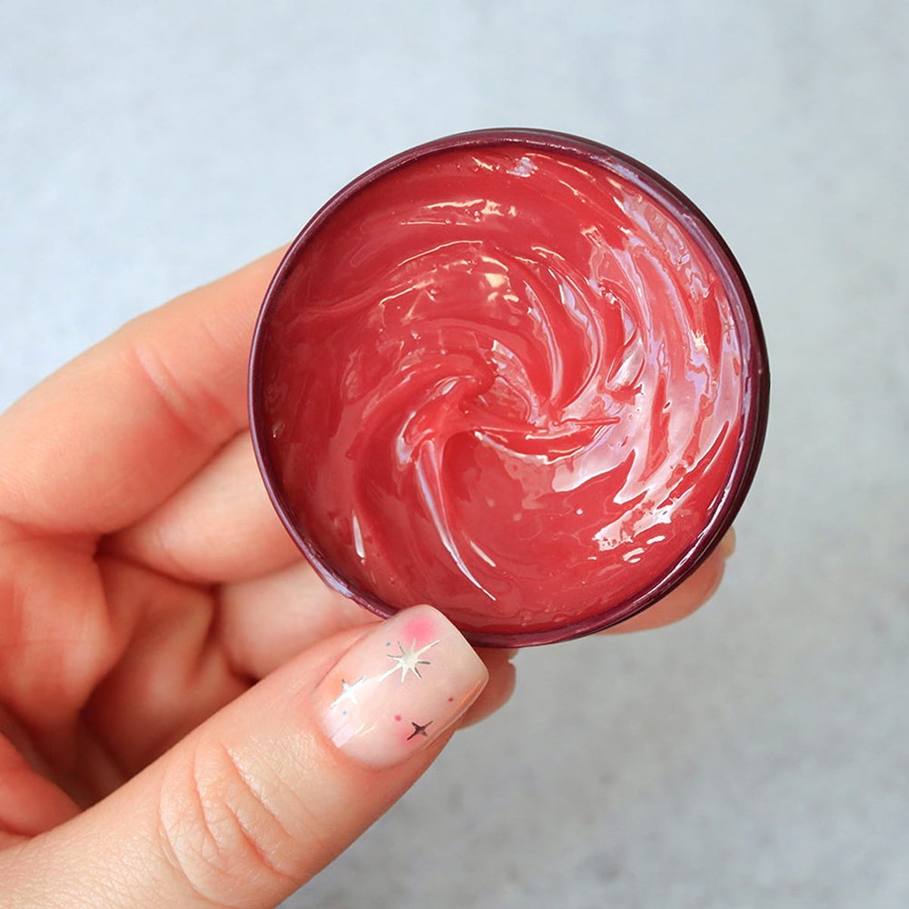 C.O. Bigelow Apple Salve Lip Tin (0.8 oz) - product shown opened held in hand showing balm