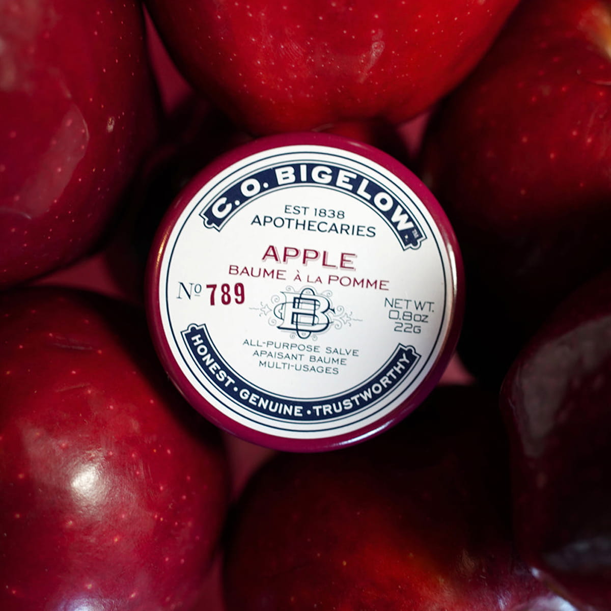 C.O. Bigelow Apple Salve Lip Tin (0.8 oz) - product lid with text shown with red apples
