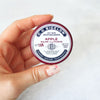C.O. Bigelow Apple Salve Lip Tin (0.8 oz) - product shown being held in hand 