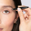 Tweezerman Mini Slant Tweezer - Black Leopard (1 pc) - product shown in hand being used on eyebrow