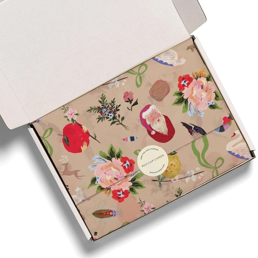 An open white cardboard box containing Red Cap Cards Merry Christmas To You Tissue Paper