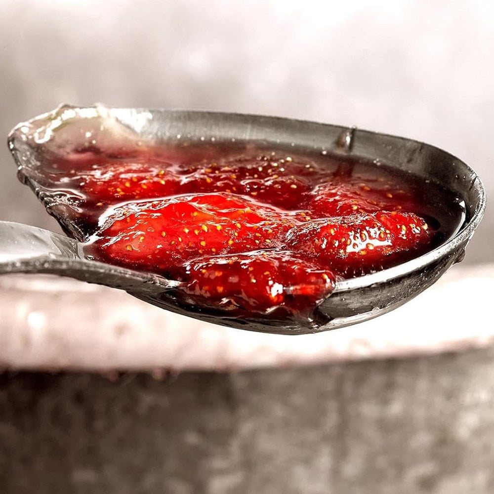 A close-up of Andresy a l'Ancienne Wild Strawberry Jam on ladle